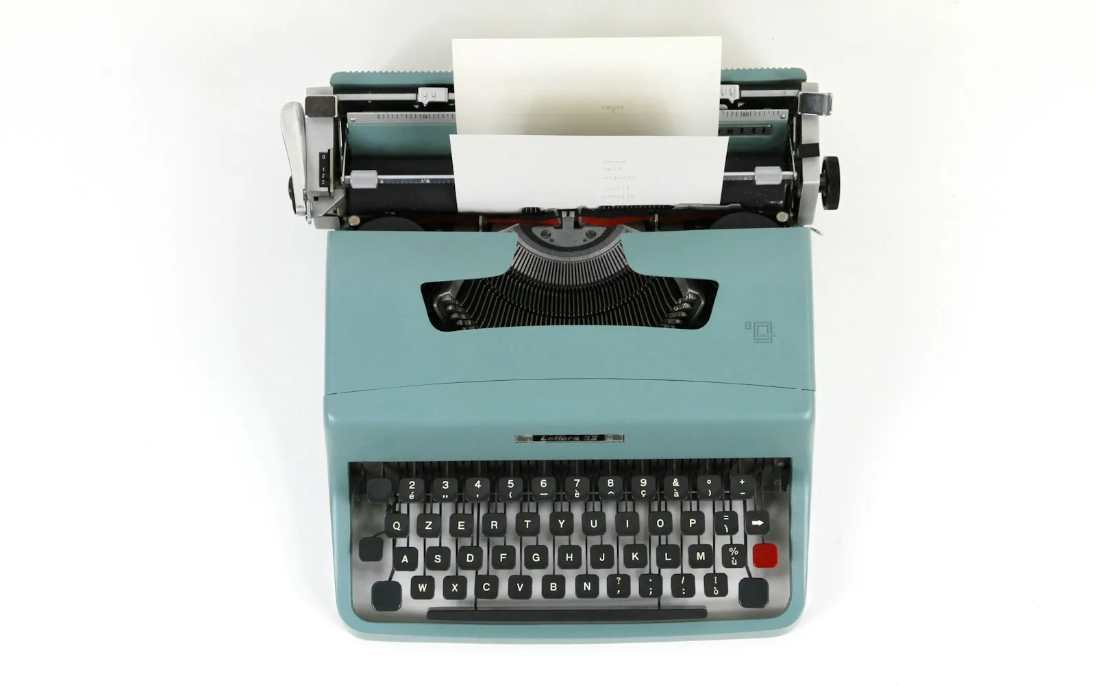 Teal and black typewriter machine